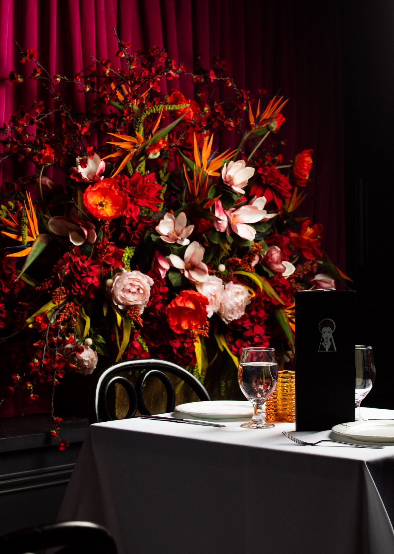 A floral table setting in the main dining room at Sei Less